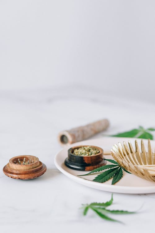 a leaf and cannabis on a plate
