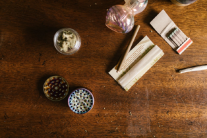 Cannabis grinder and accessories on wood