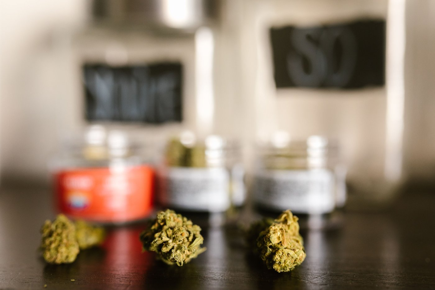 Cannabis buds and product jars displayed