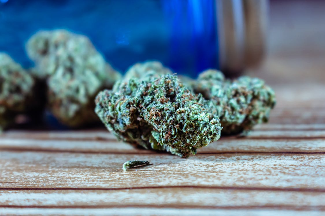 Cannabis flower displayed on a wooden surface.